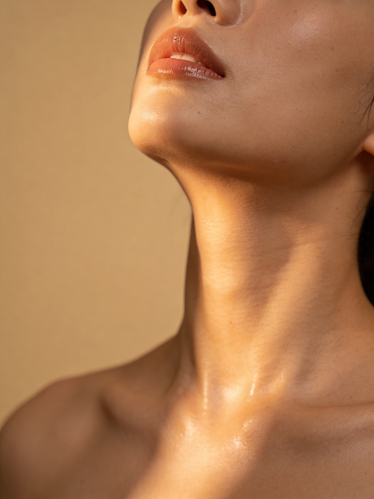 Close-up beauty portrait in warm natural light, representing the confidence aesthetic patients seek