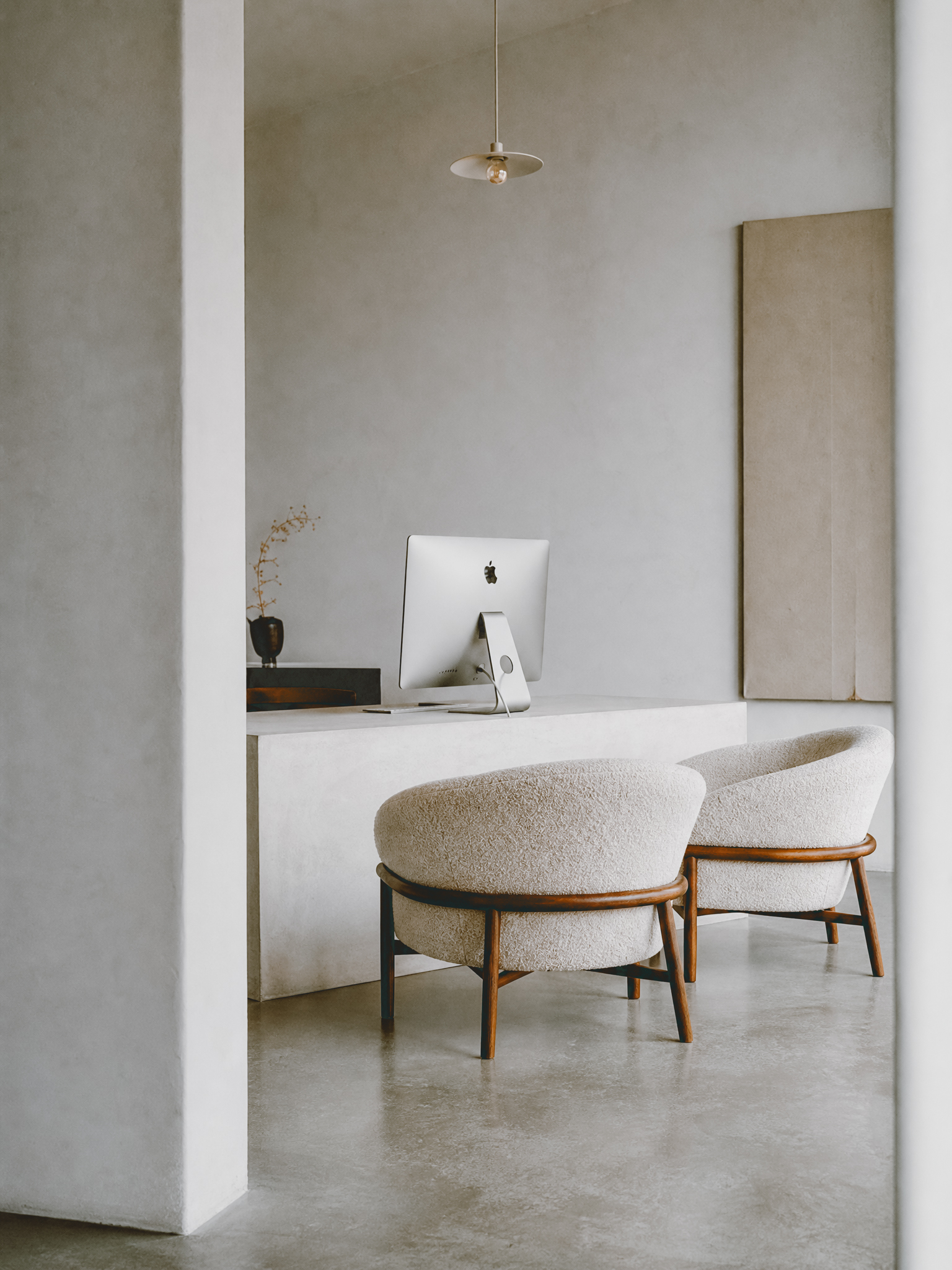 A quiet, minimalist aesthetic-practice office with soft furniture and natural light